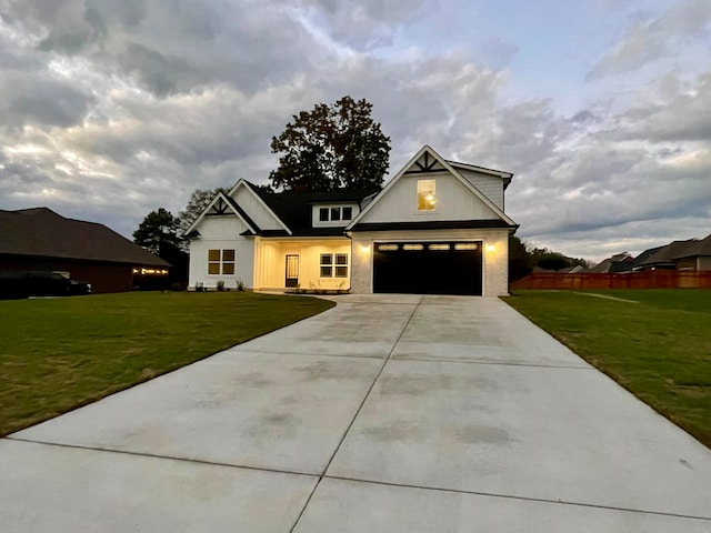 modern farmhouse style home with a garage and a front lawn