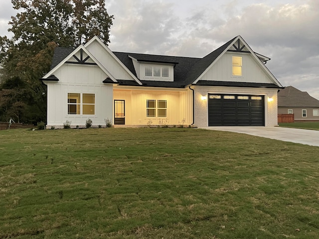 modern farmhouse style home featuring a garage and a front lawn