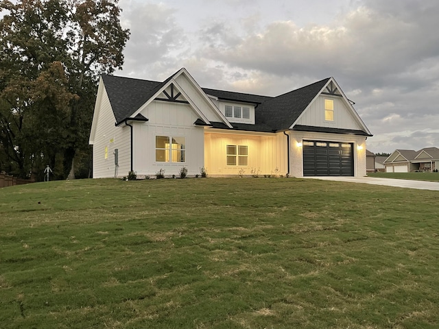 modern inspired farmhouse featuring a garage and a front lawn