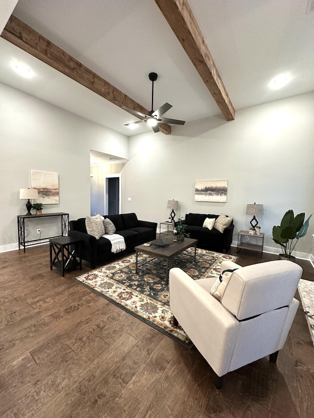 living room featuring beam ceiling, dark hardwood / wood-style flooring, and ceiling fan