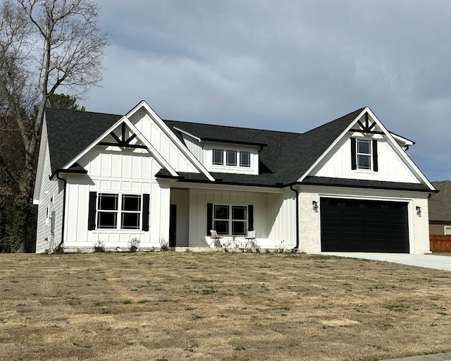 modern inspired farmhouse featuring concrete driveway, an attached garage, a front lawn, board and batten siding, and brick siding