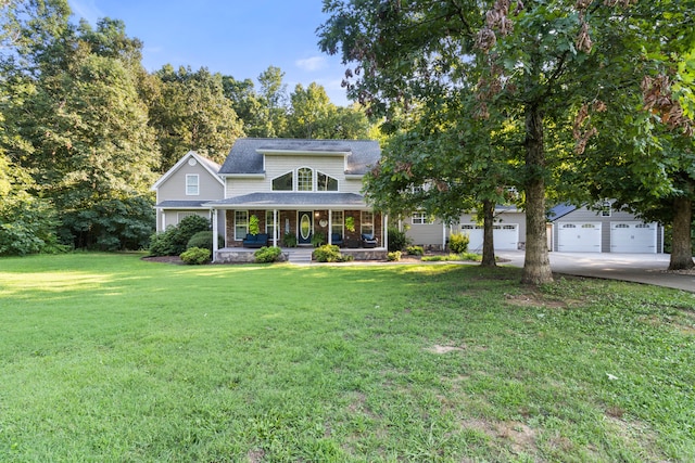 view of front of home featuring a garage, covered porch, an outbuilding, and a front lawn