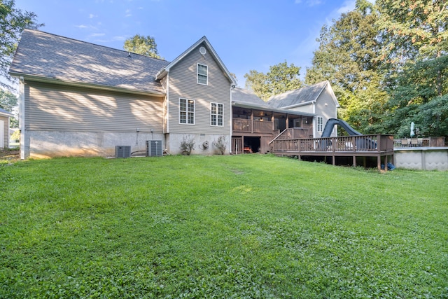 back of house with a lawn, cooling unit, and a deck