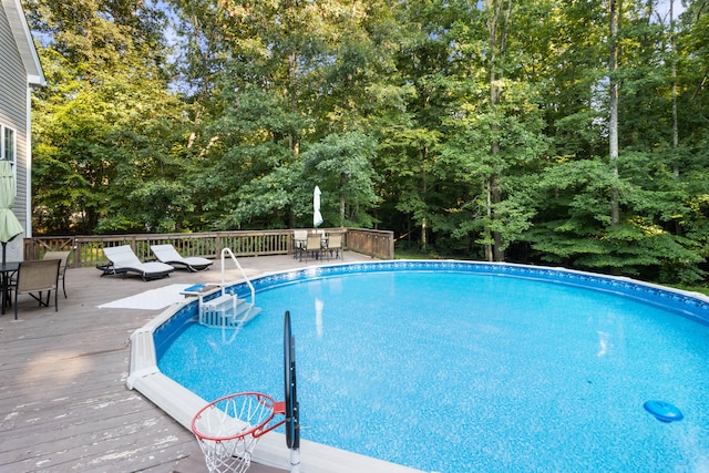 view of swimming pool with a deck