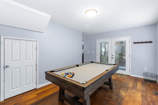 rec room with a textured ceiling, dark wood-type flooring, pool table, and french doors