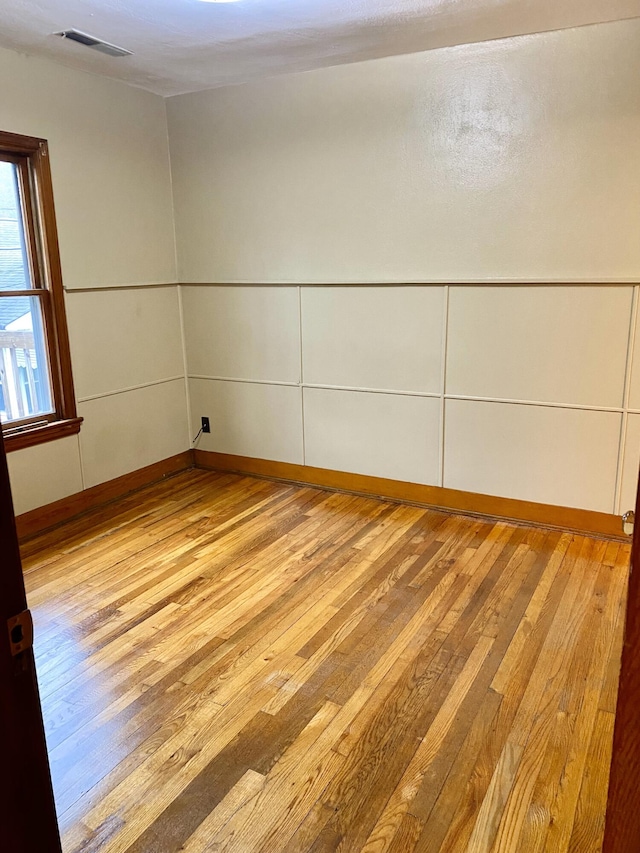 spare room with light wood-type flooring