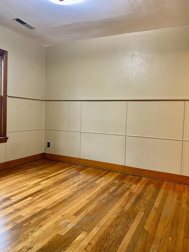 spare room with light hardwood / wood-style flooring