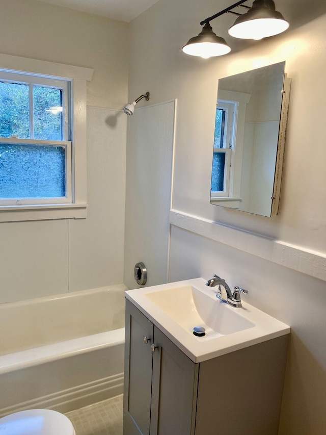 full bathroom featuring vanity, toilet, and washtub / shower combination