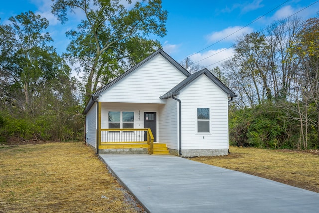 view of front of property with a porch and a front yard