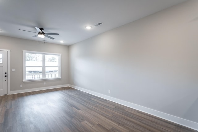 spare room with ceiling fan and dark hardwood / wood-style flooring