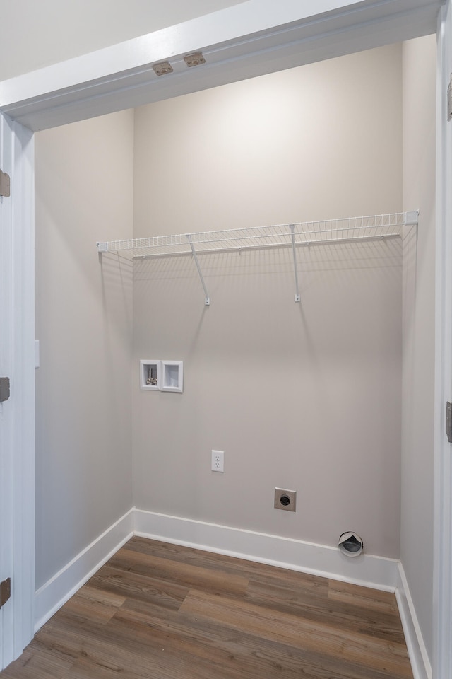 clothes washing area featuring electric dryer hookup, hookup for a washing machine, and dark hardwood / wood-style floors