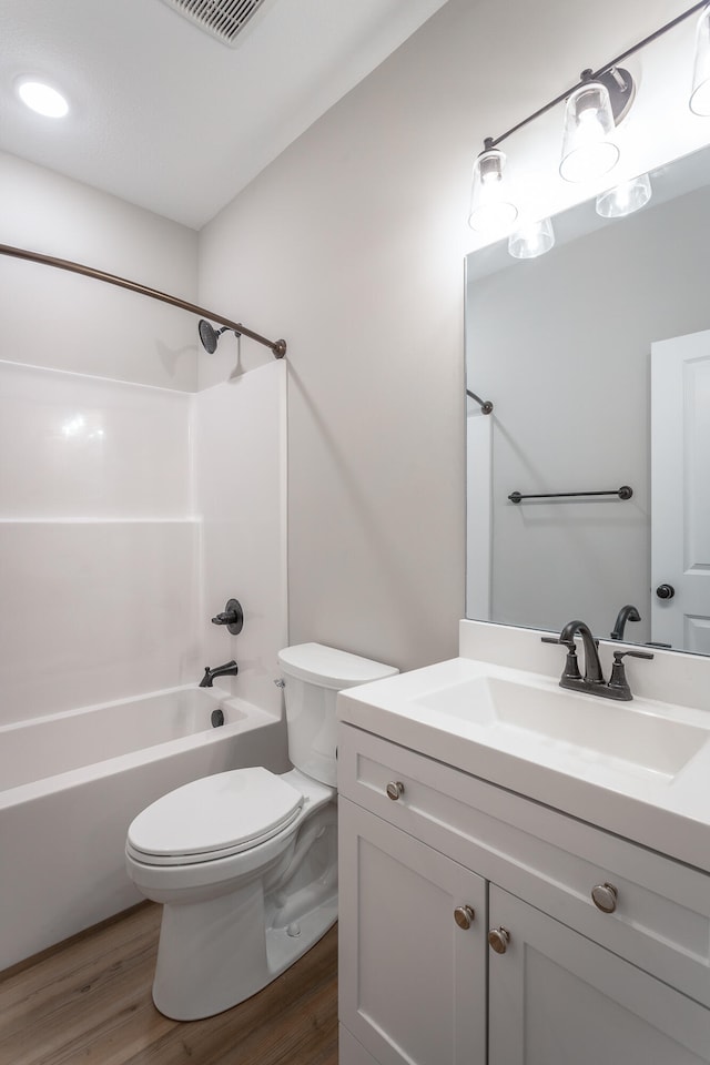 full bathroom featuring vanity, toilet, shower / bathing tub combination, and hardwood / wood-style flooring