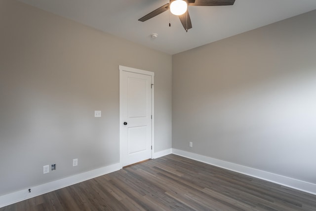 spare room with dark hardwood / wood-style floors and ceiling fan