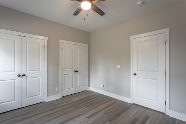 unfurnished bedroom with dark hardwood / wood-style floors and ceiling fan