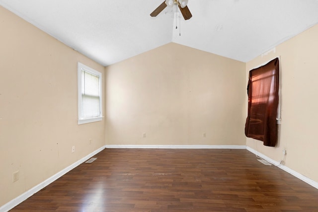 empty room with ceiling fan, lofted ceiling, and dark wood-type flooring