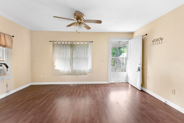 unfurnished room with ceiling fan, dark hardwood / wood-style flooring, and a textured ceiling