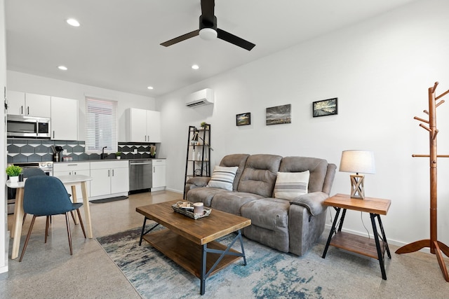 living room featuring sink, a wall mounted AC, and ceiling fan