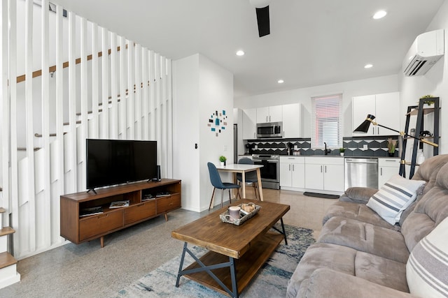 living room featuring sink and a wall unit AC