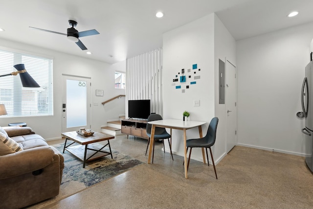 living room featuring electric panel and ceiling fan