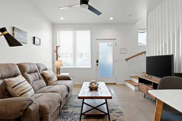 carpeted living room featuring ceiling fan