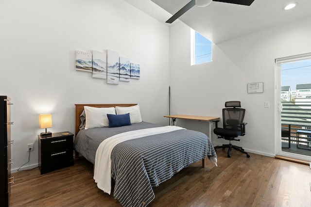 bedroom featuring access to outside, dark hardwood / wood-style floors, and ceiling fan