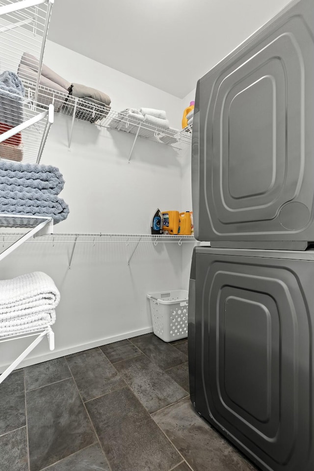 laundry room with stacked washer / drying machine