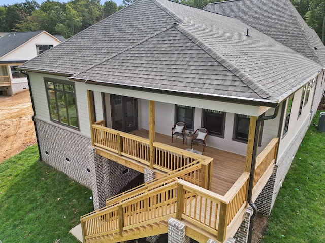 back of house with a wooden deck and a yard