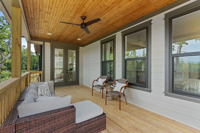 wooden terrace with ceiling fan, french doors, and an outdoor hangout area