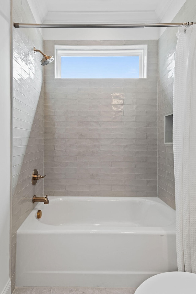 bathroom featuring shower / bath combination with curtain, toilet, crown molding, and a wealth of natural light