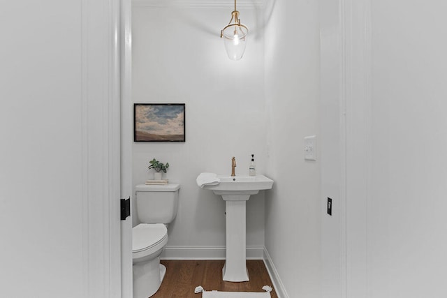 bathroom featuring wood-type flooring and toilet