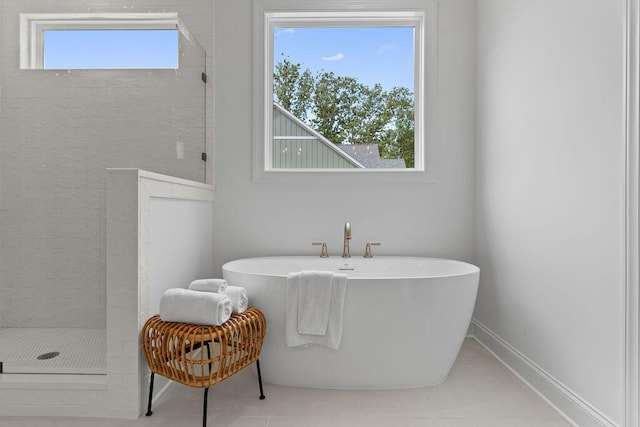 bathroom with tile patterned floors and shower with separate bathtub