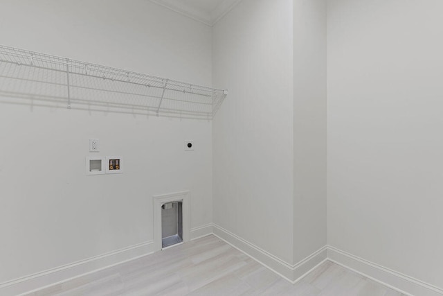 laundry room featuring electric dryer hookup, light hardwood / wood-style floors, ornamental molding, and hookup for a washing machine