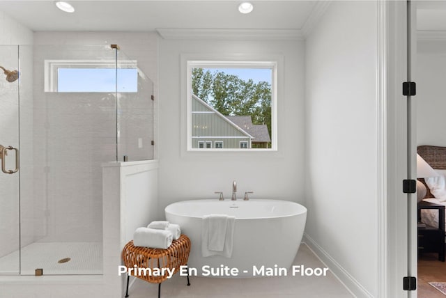 bathroom featuring crown molding and shower with separate bathtub