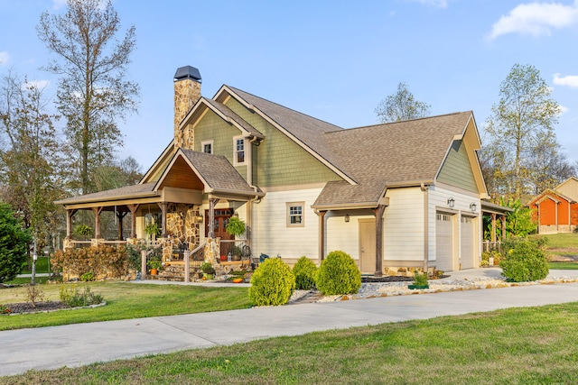 craftsman-style house featuring a front lawn, covered porch, and a garage