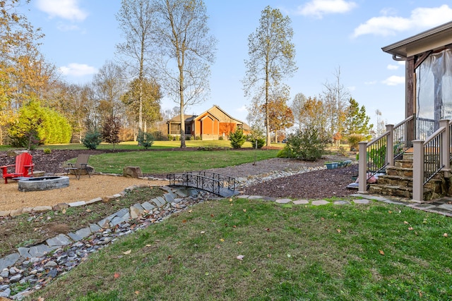 view of yard with an outdoor fire pit