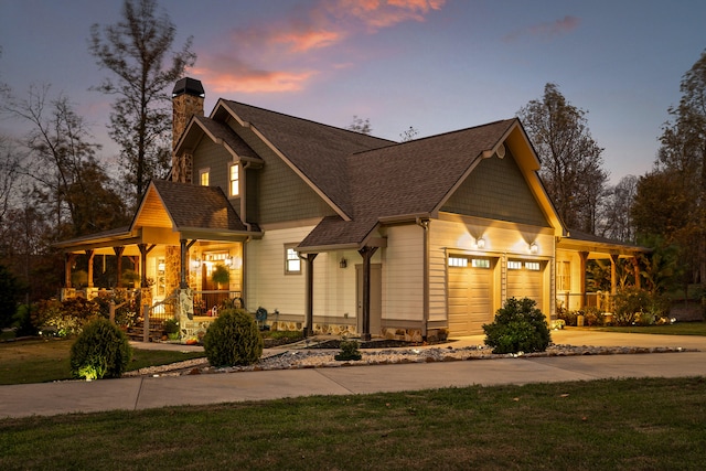 craftsman-style home with a yard, covered porch, and a garage