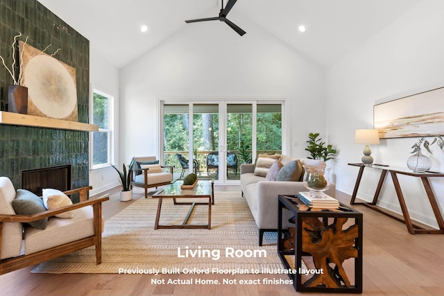 living room featuring plenty of natural light, high vaulted ceiling, and light hardwood / wood-style flooring