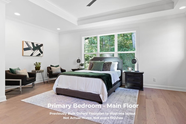 bedroom featuring a tray ceiling, crown molding, ceiling fan, and hardwood / wood-style flooring