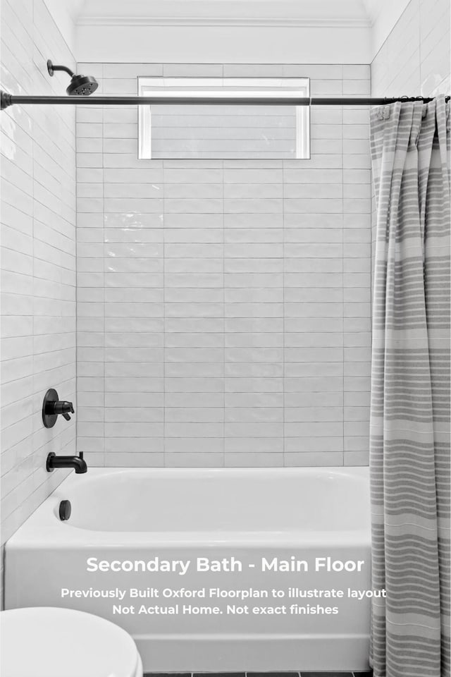 bathroom featuring shower / bath combo with shower curtain, toilet, and crown molding