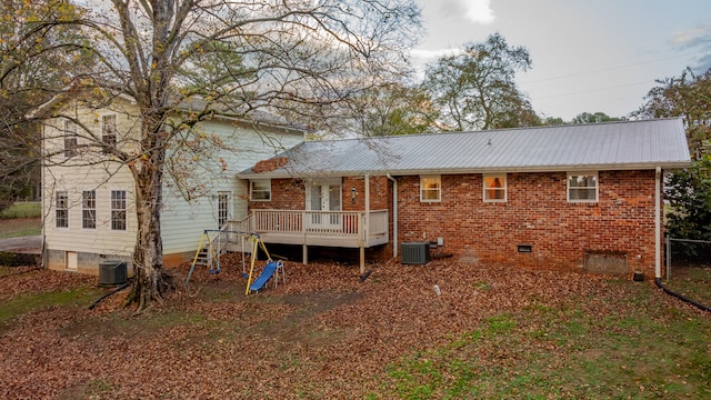 back of property featuring a deck and cooling unit