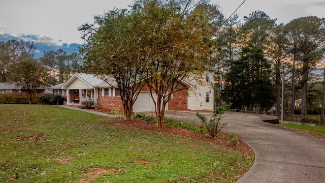 obstructed view of property featuring a front yard and a garage