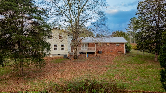 back of property featuring a wooden deck