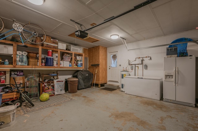 garage featuring water heater, white fridge with ice dispenser, a garage door opener, and fridge