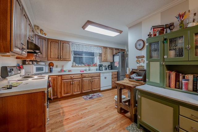 kitchen featuring sink, light wood-type flooring, white appliances, and ornamental molding