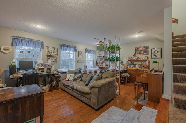 living room featuring hardwood / wood-style floors and a textured ceiling