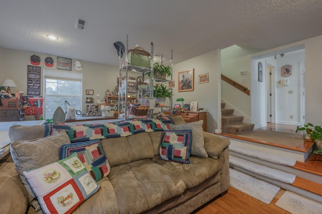 living room featuring hardwood / wood-style flooring and a textured ceiling