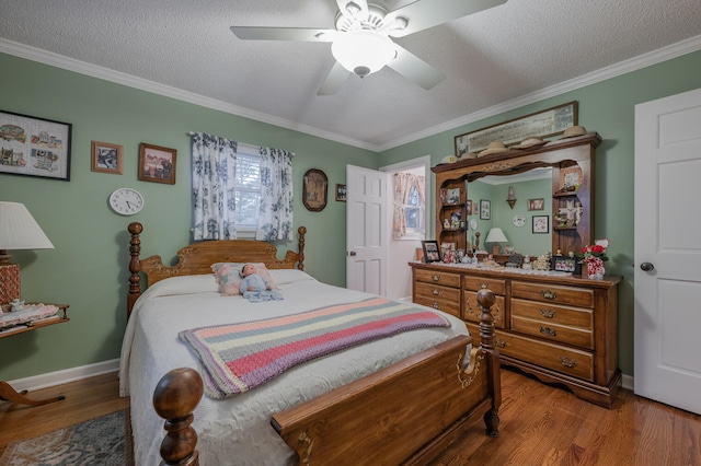 bedroom featuring ceiling fan, crown molding, and hardwood / wood-style flooring