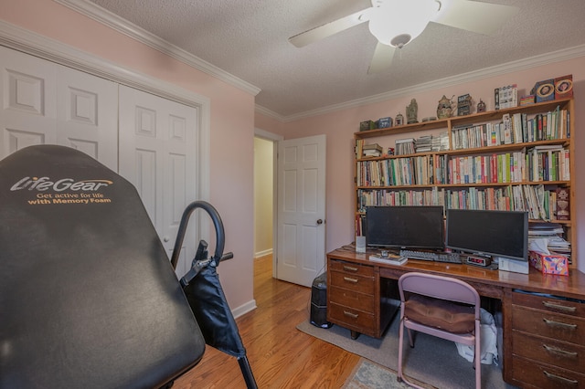 office featuring a textured ceiling, ceiling fan, light hardwood / wood-style floors, and crown molding