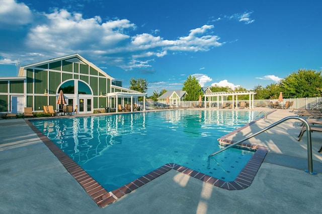 view of pool with a pergola and a patio