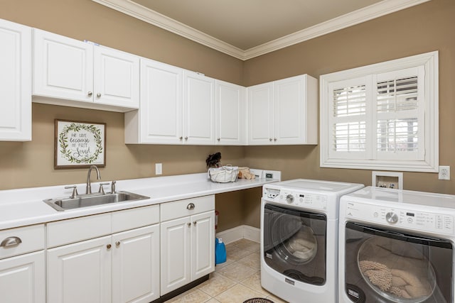 washroom with cabinets, ornamental molding, sink, washer and dryer, and light tile patterned floors